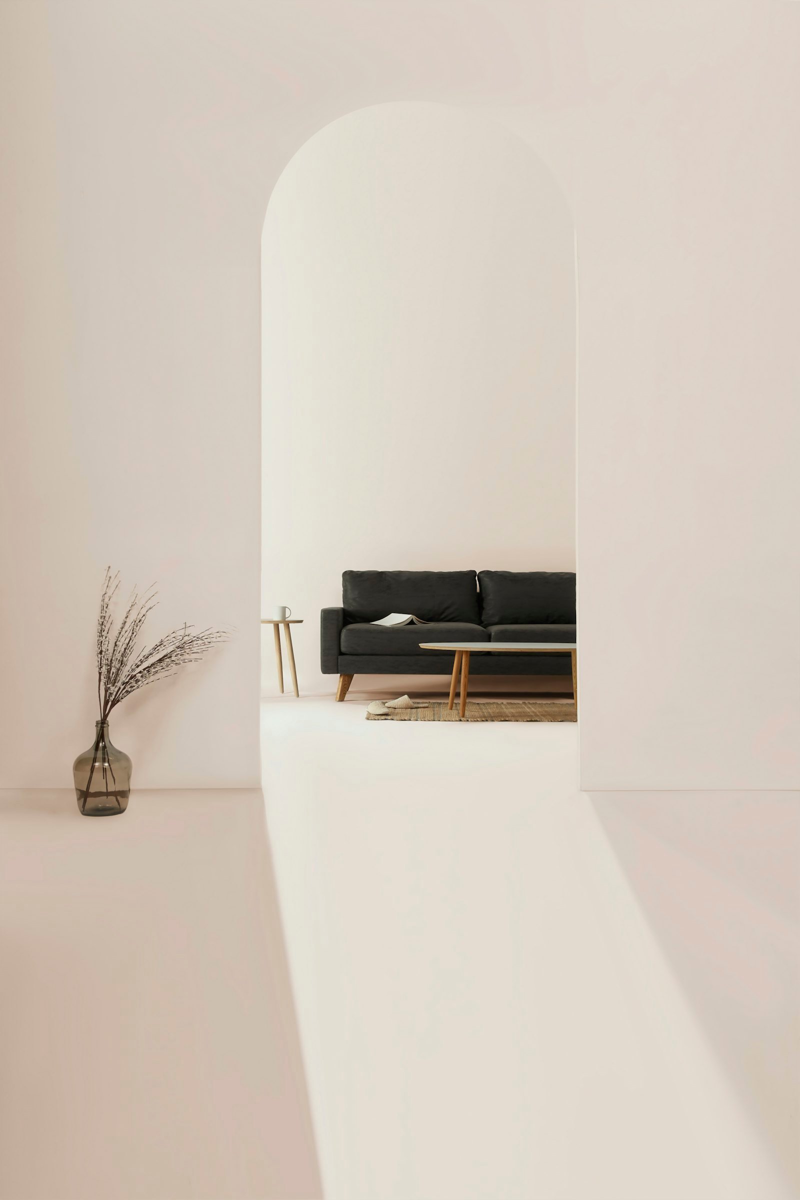 A dark upholstered sofa seen through a pale arch