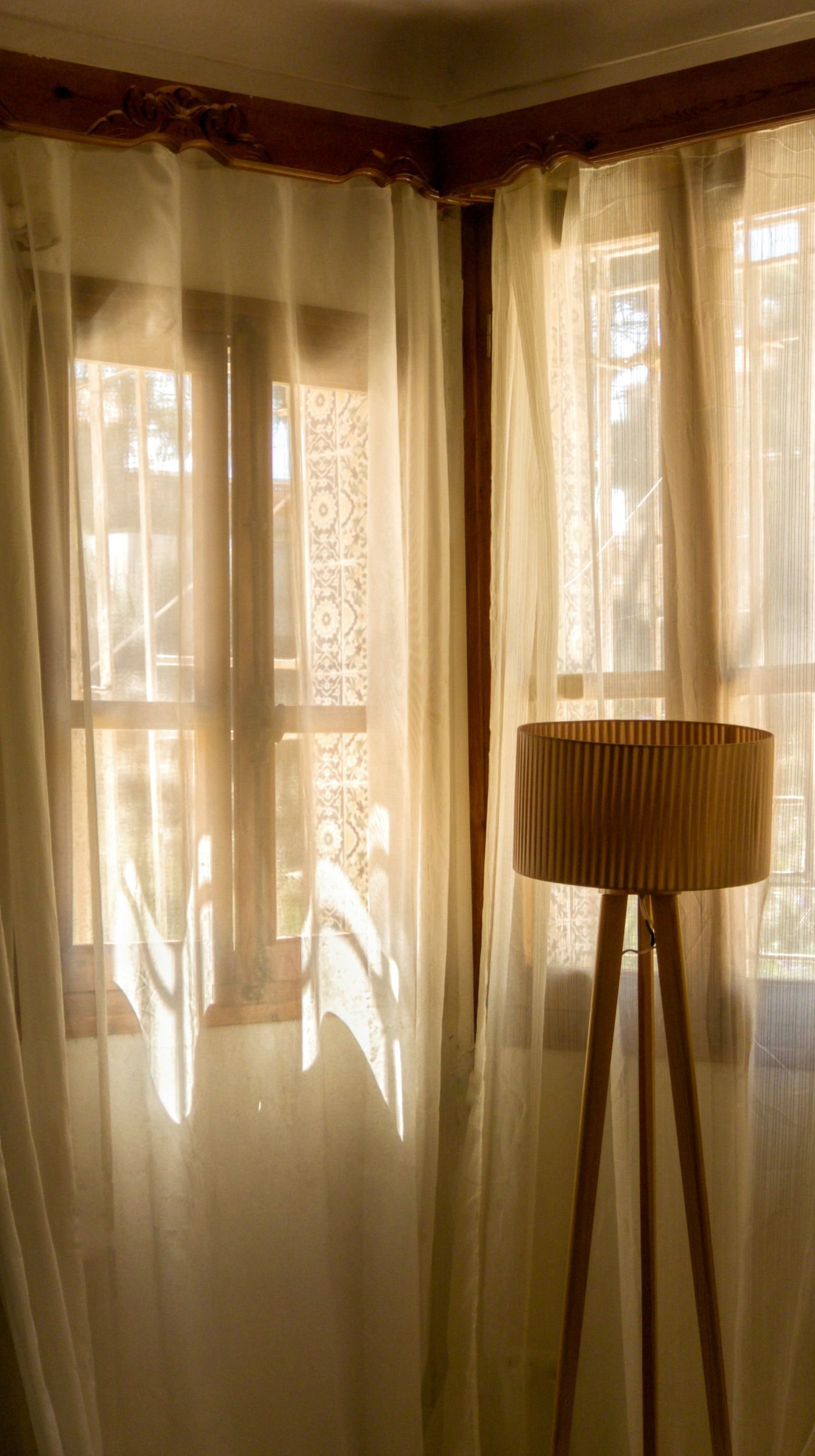 Sheer curtains covering a corner of windows